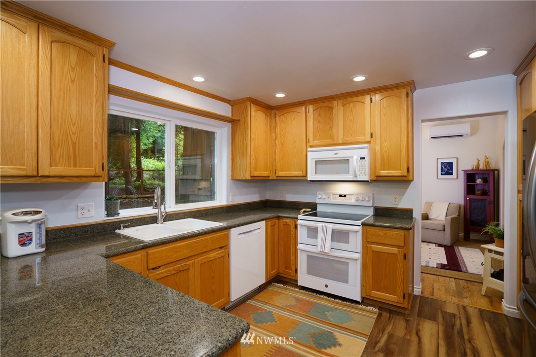 1230 Cedar Circle Langley, WA 98260 - Photo 8 of 39 a kitchen with stainless steel appliances granite countertop sink stove and cabinets