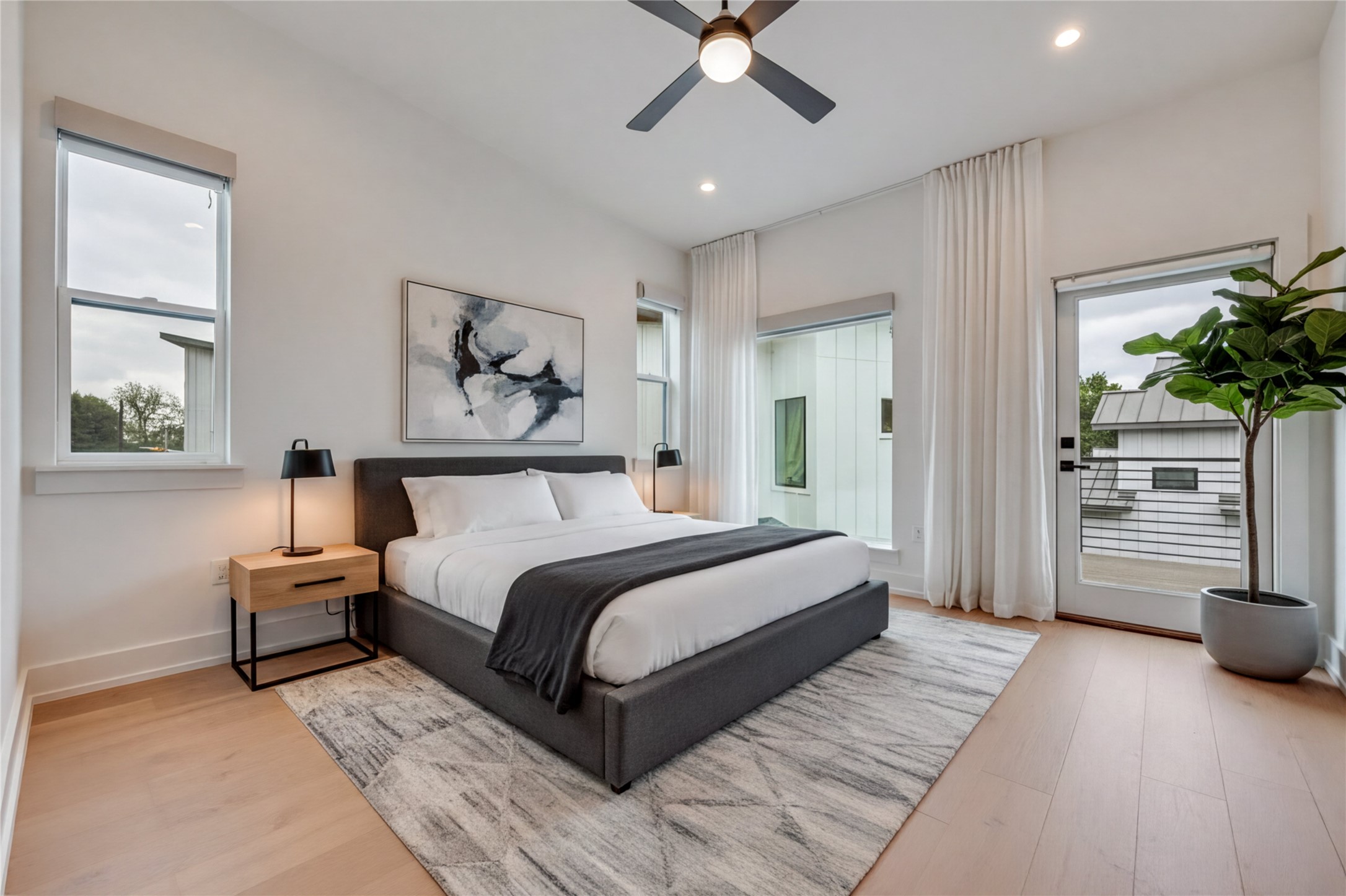 108 Tillery Street, Unit 1 Austin, TX 78702 - Photo 13 of 40 a bedroom with a large bed and a chandelier