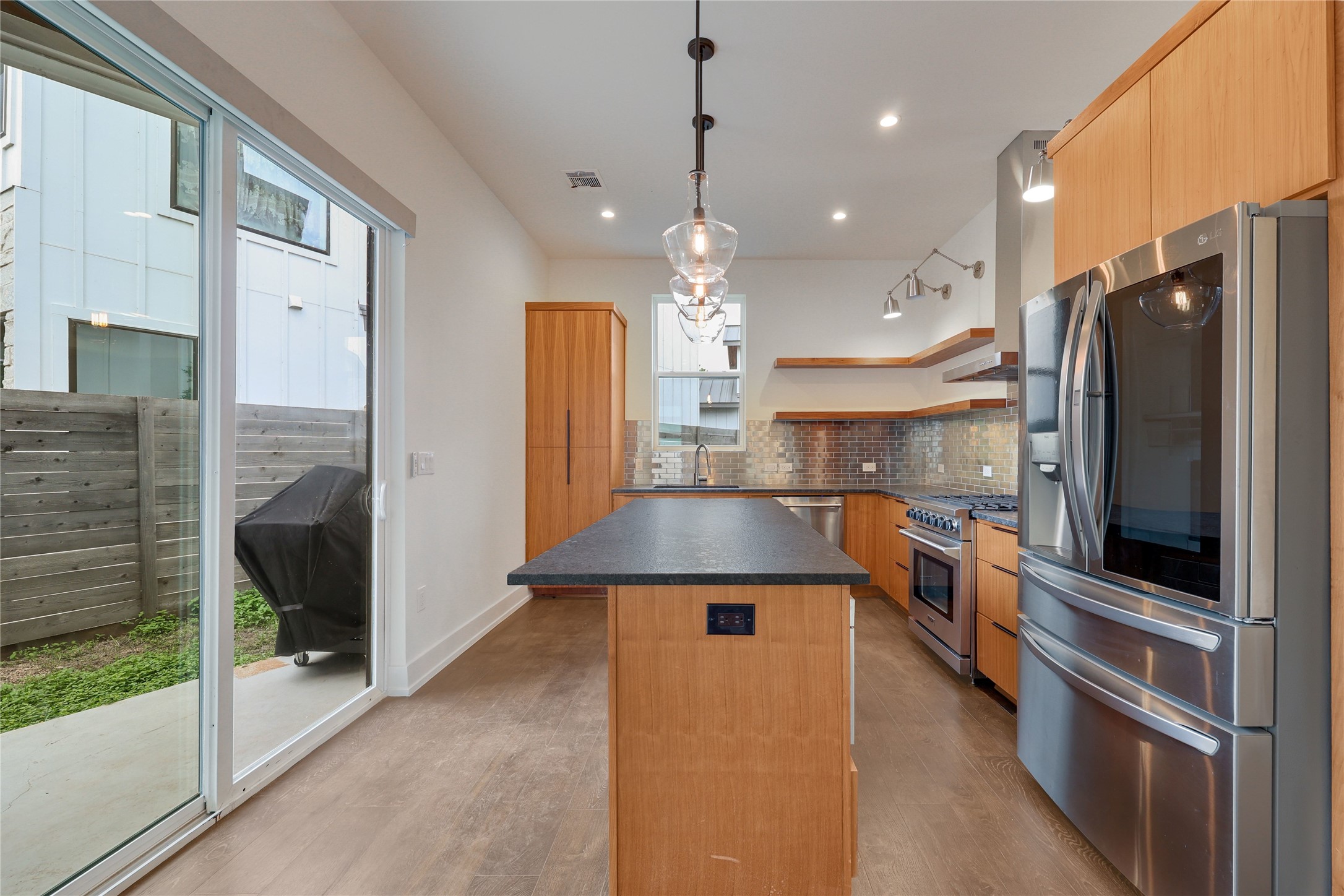 108 Tillery Street, Unit 1 Austin, TX 78702 - Photo 7 of 40 a kitchen with stainless steel appliances granite countertop a refrigerator a oven and a sink with large window