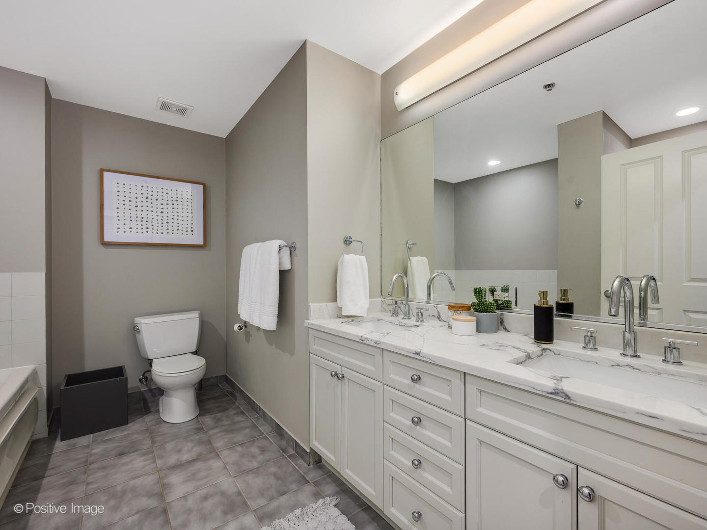 1250 South Michigan Avenue, Unit 910 Chicago, IL 60605 - Photo 14 of 26 a bathroom with a toilet sink and mirror