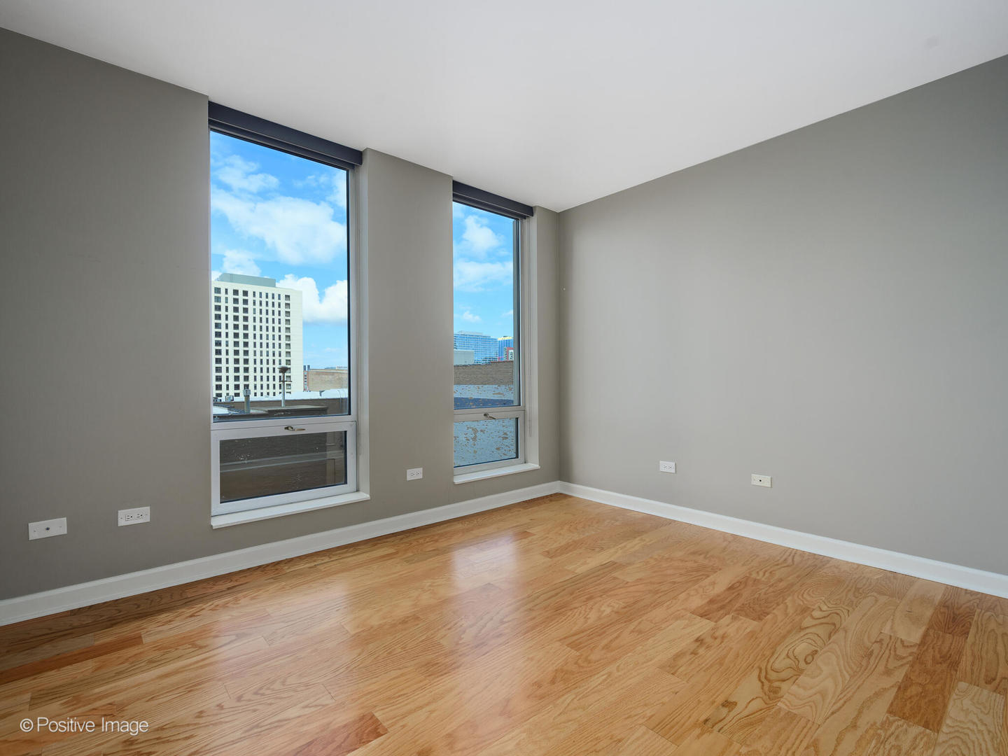 1250 South Michigan Avenue, Unit 910 Chicago, IL 60605 - Photo 16 of 26 a view of an empty room with a window and wooden floor