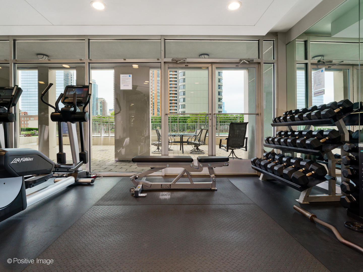 1250 South Michigan Avenue, Unit 910 Chicago, IL 60605 - Photo 20 of 26 a room with gym equipment and floor to ceiling window