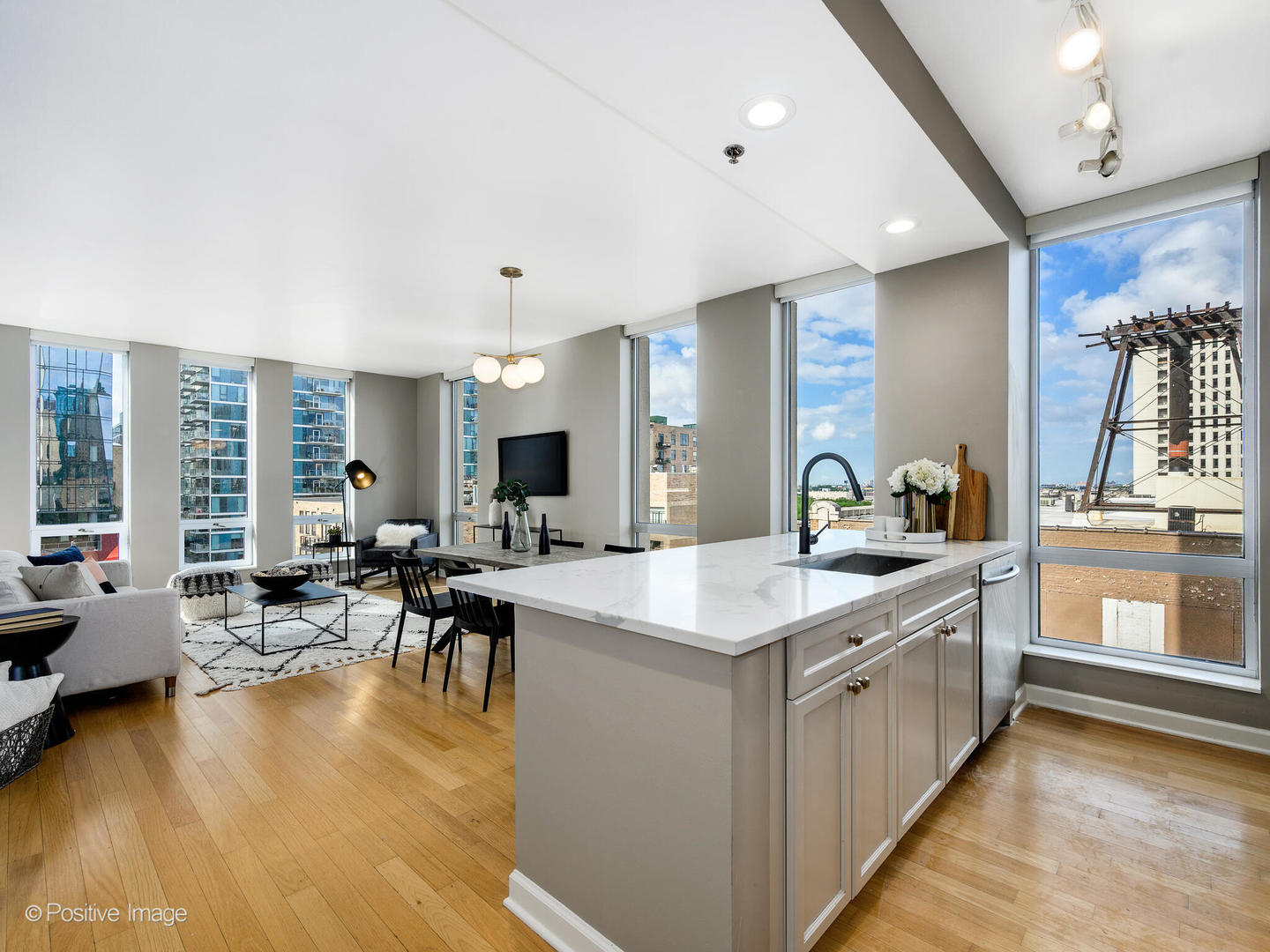 1250 South Michigan Avenue, Unit 910 Chicago, IL 60605 - Photo 3 of 26 a large kitchen with kitchen island a sink table and chairs