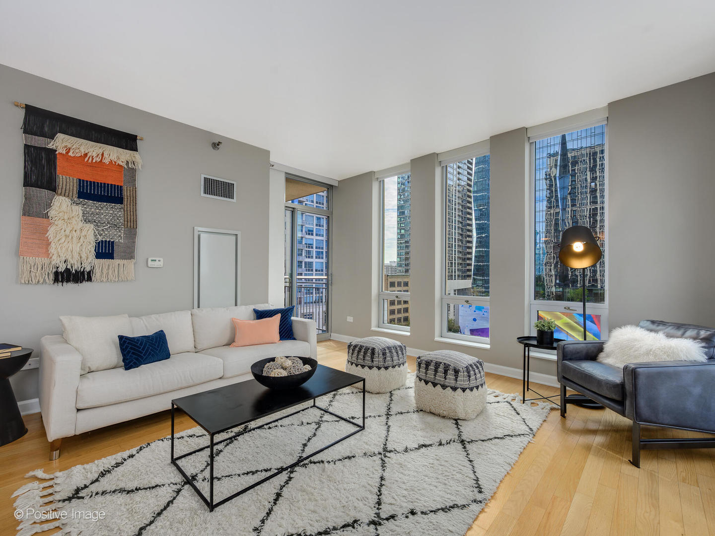 1250 South Michigan Avenue, Unit 910 Chicago, IL 60605 - Photo 5 of 26 a living room with furniture and floor to ceiling windows
