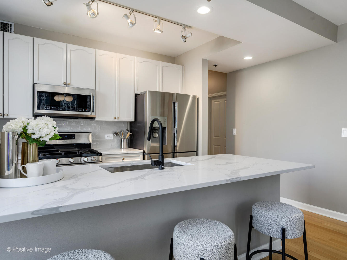 1250 South Michigan Avenue, Unit 910 Chicago, IL 60605 - Photo 10 of 26 a kitchen with stainless steel appliances a refrigerator sink and microwave