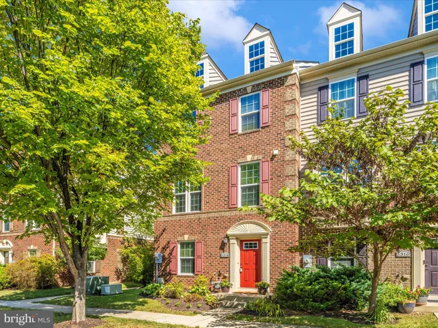 a view of a brick house with large windows