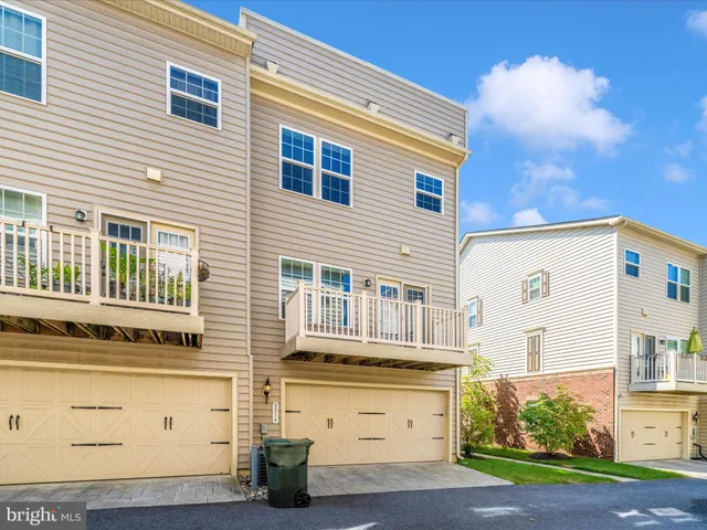 a view of a brick house with potted plants