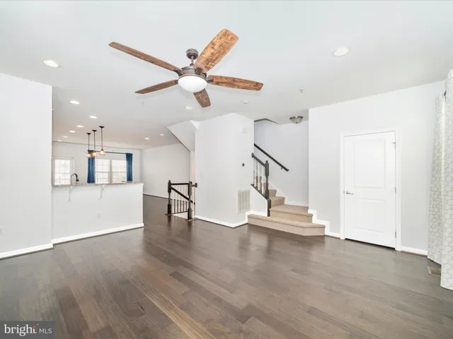 a view of a kitchen with a sink and a refrigerator