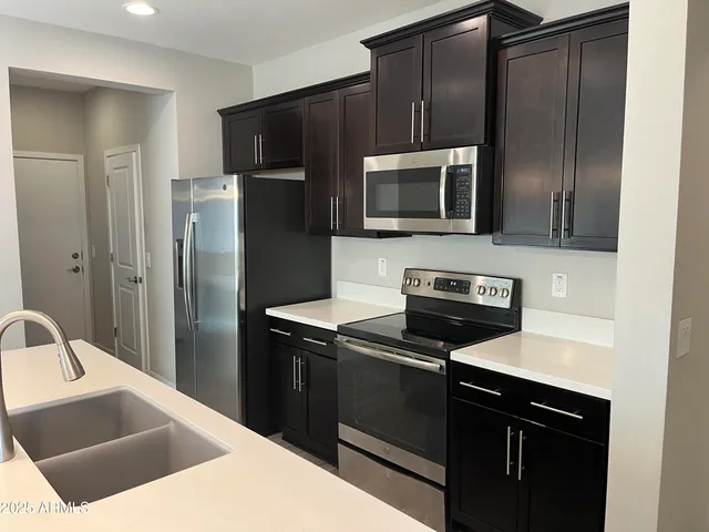 a kitchen with a refrigerator stove and microwave