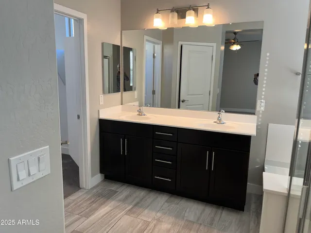 a bathroom with a double vanity sink and a mirror