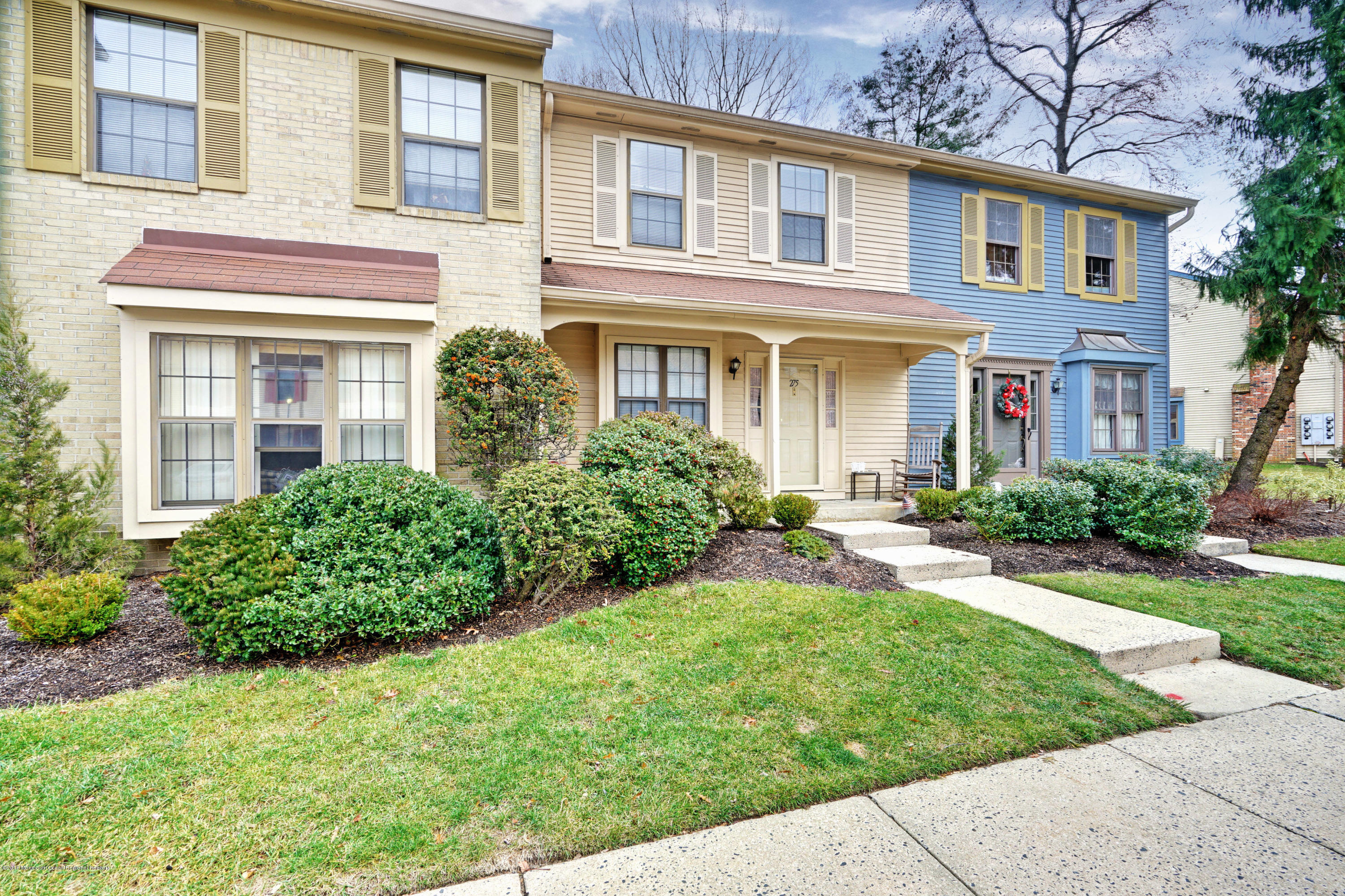 front view of a brick house with a yard