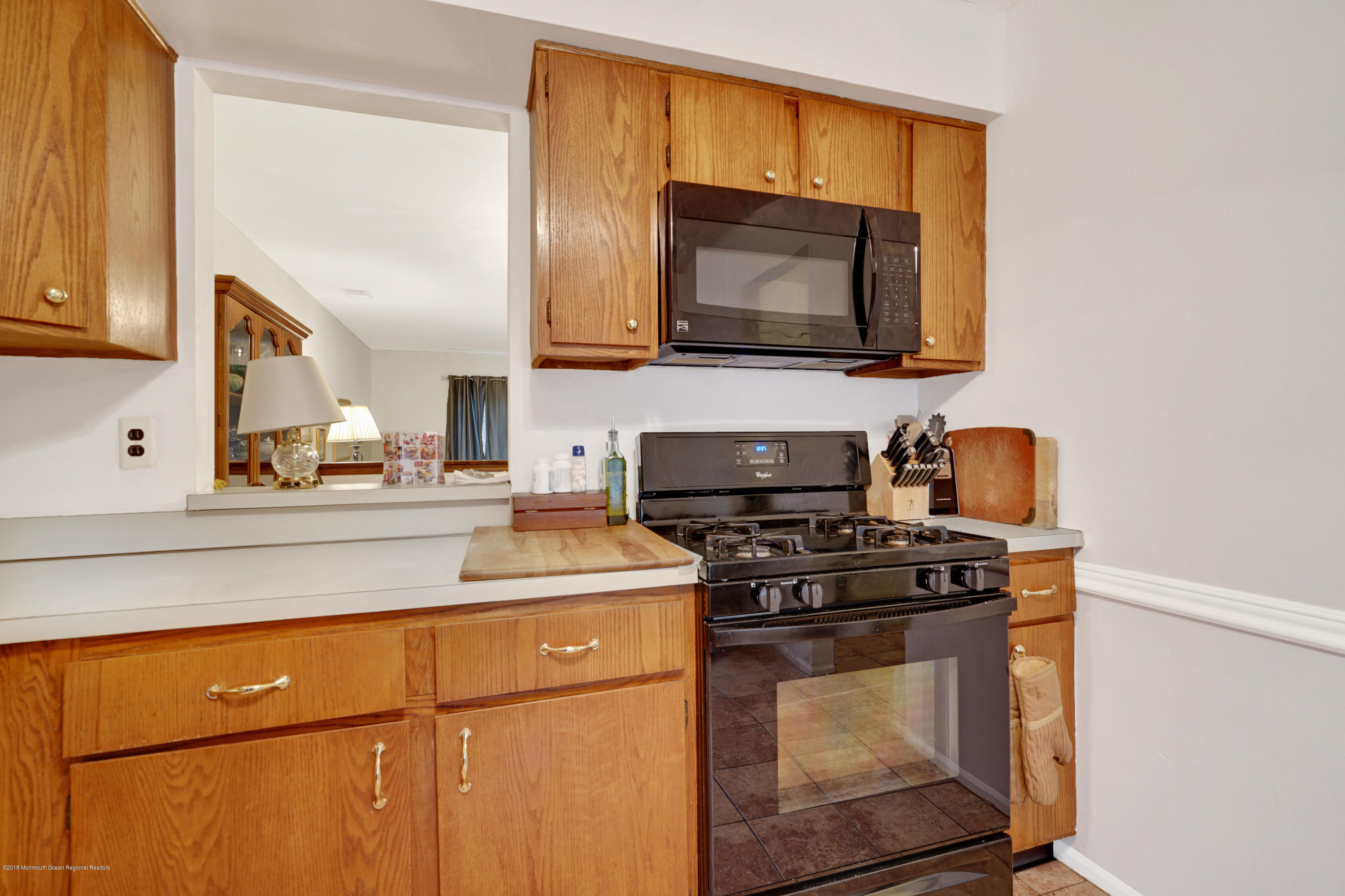275 Gloucester Court Aberdeen, NJ 07747 - Photo 12 of 31 a kitchen with a stove and a microwave
