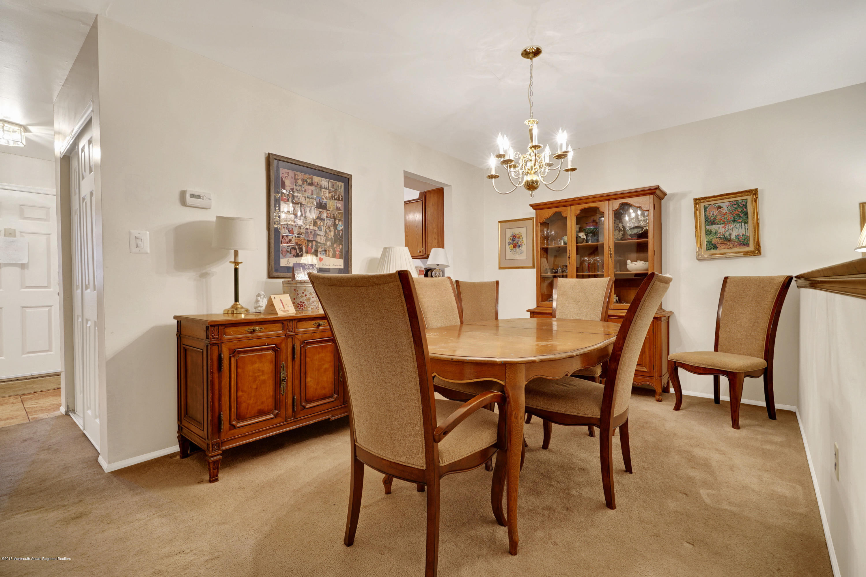 275 Gloucester Court Aberdeen, NJ 07747 - Photo 14 of 31 a view of a dining room with furniture and chandelier