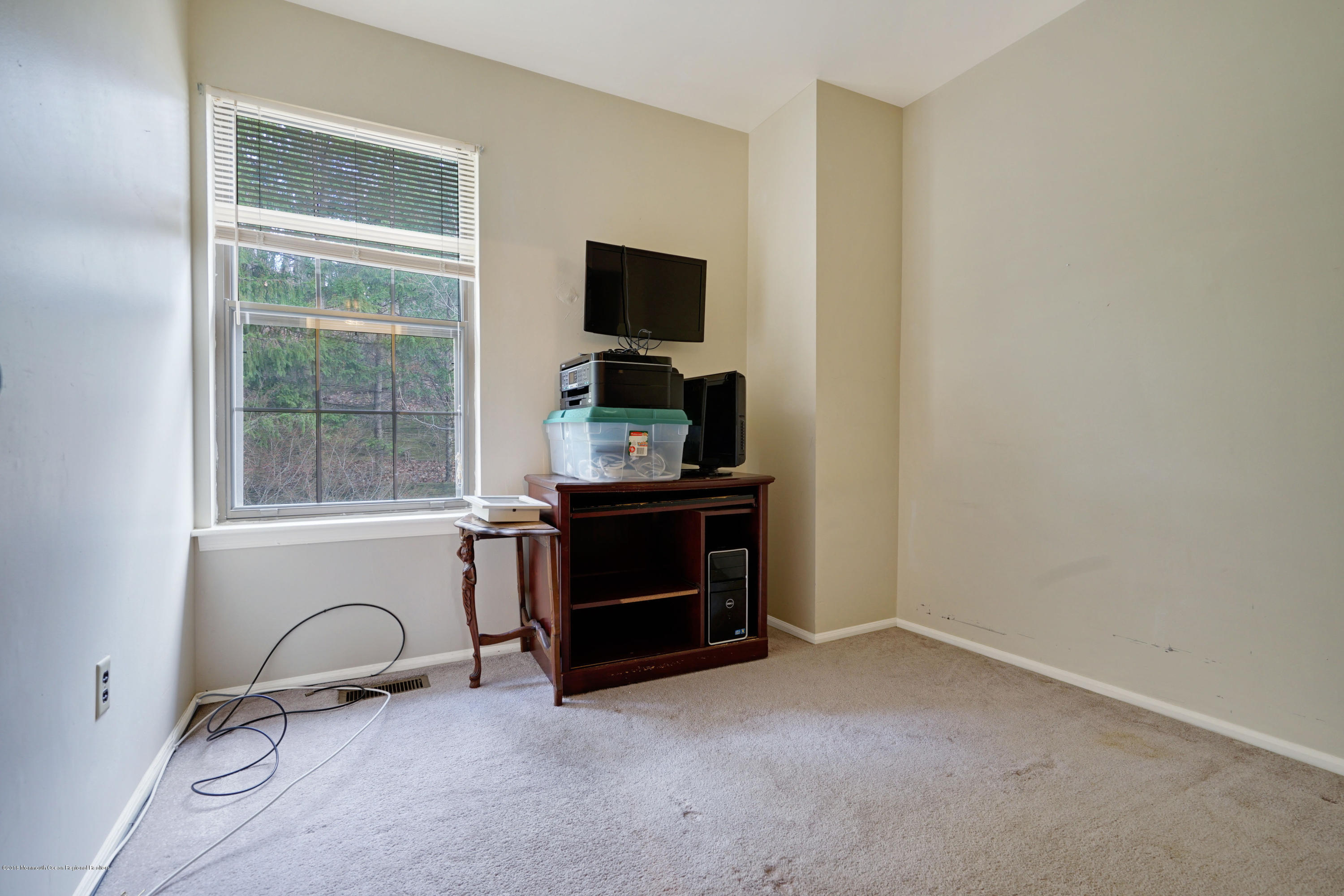 275 Gloucester Court Aberdeen, NJ 07747 - Photo 26 of 31 a room with a flat screen tv and dresser
