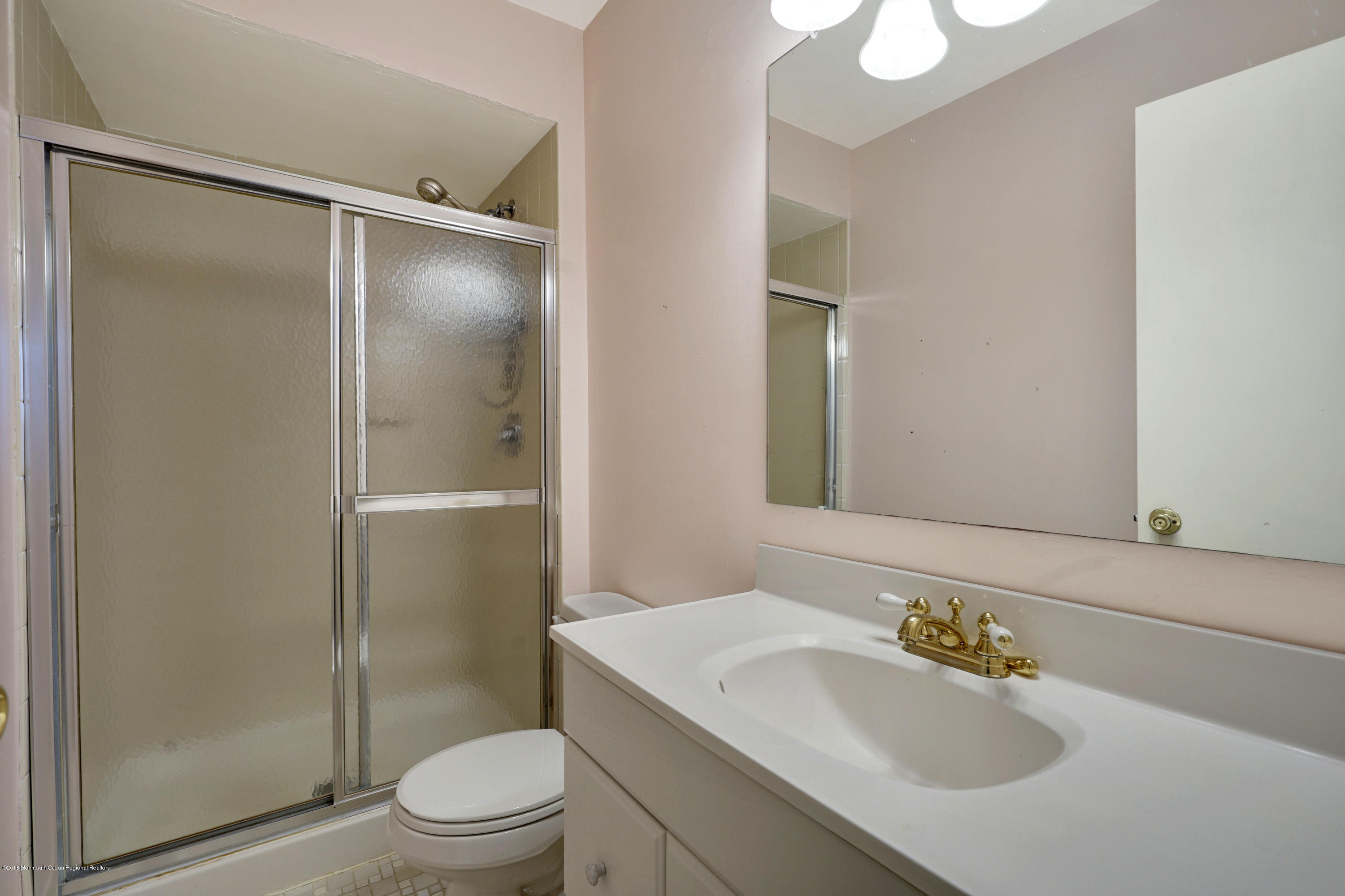 275 Gloucester Court Aberdeen, NJ 07747 - Photo 28 of 31 a bathroom with a sink toilet and shower