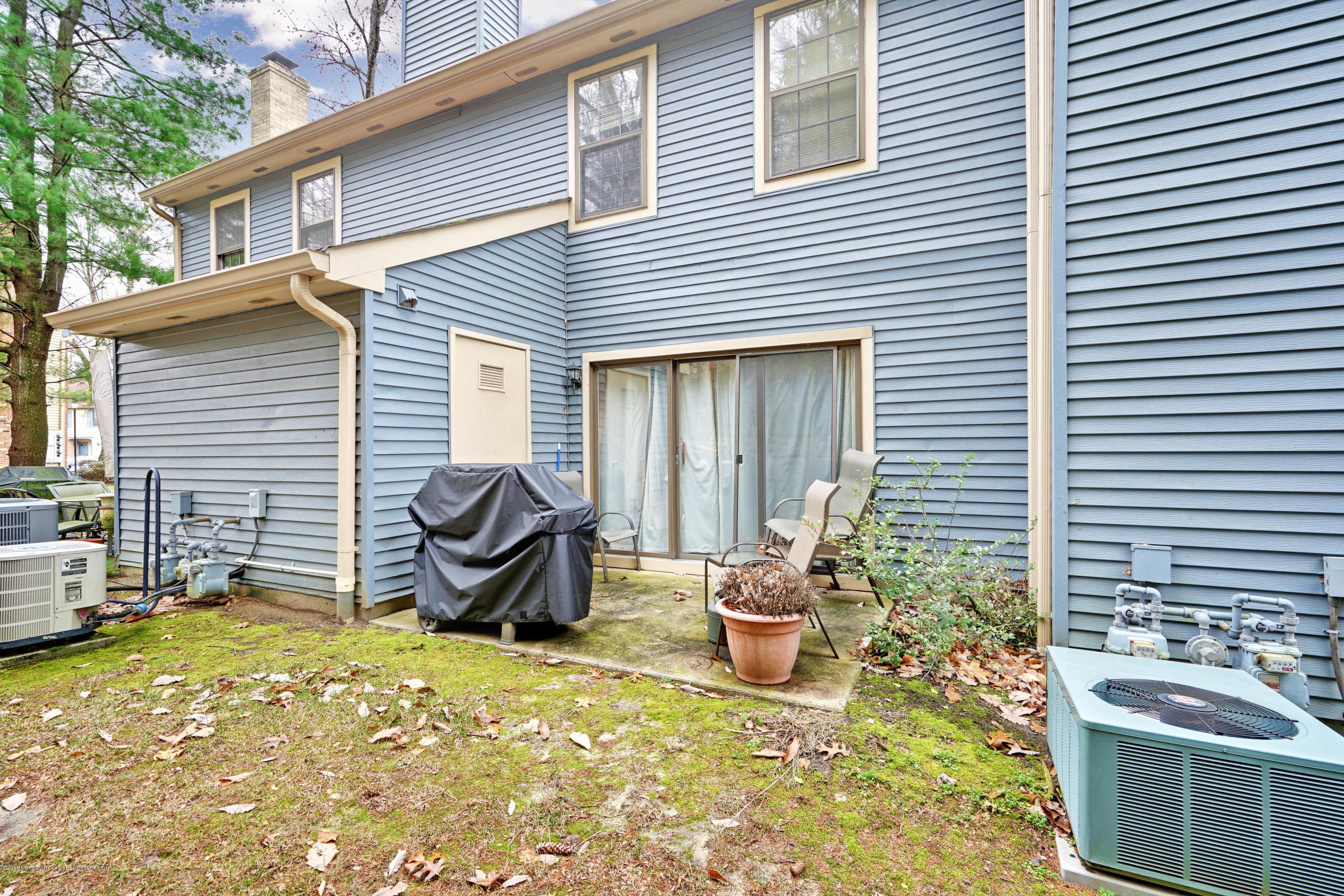 275 Gloucester Court Aberdeen, NJ 07747 - Photo 30 of 31 a view of a patio with chair and tables back yard of the house