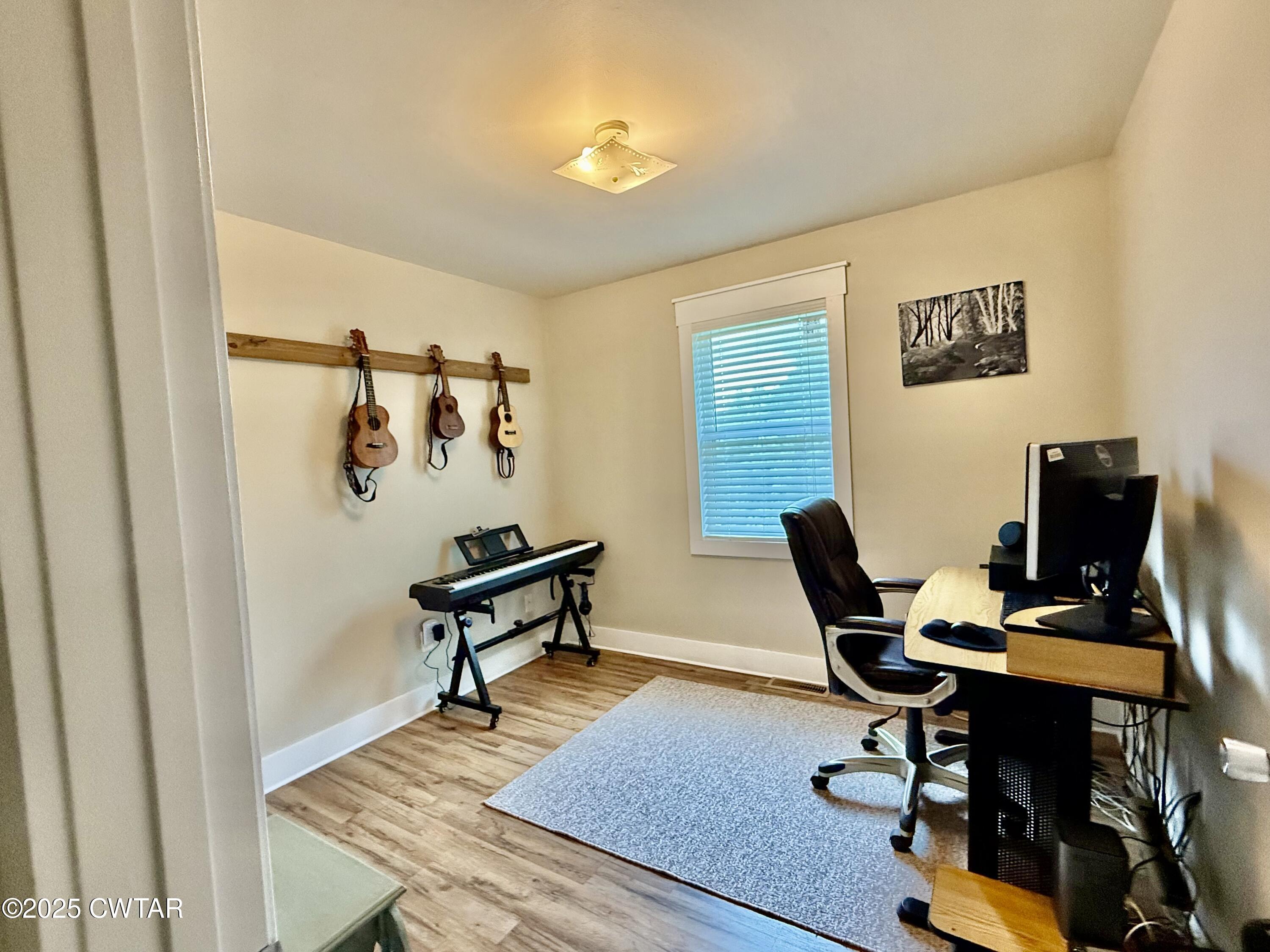 4815 Webb Store Road Hornbeak, TN 38232 - Photo 14 of 23 a view of a workspace with furniture and a window