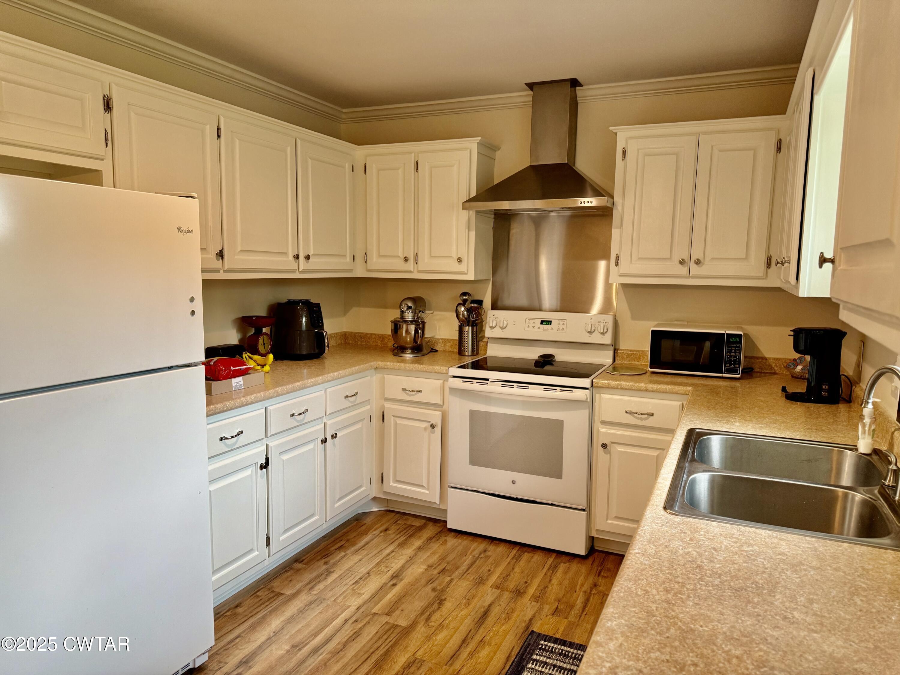 4815 Webb Store Road Hornbeak, TN 38232 - Photo 8 of 23 a kitchen with granite countertop white cabinets and white appliances