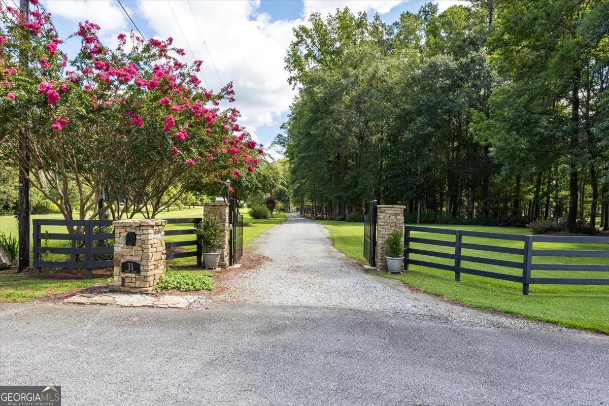 a view of street with wooden fence