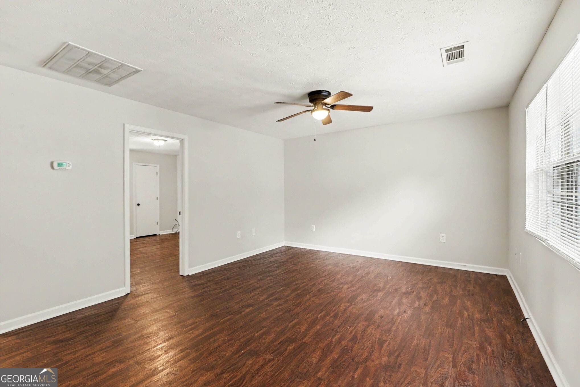 209 East Wilson Street Villa Rica, GA 30180 - Photo 4 of 24 SPACIOUS FAMILY ROOM THAT IS OPEN TO THE KITCHEN WITH LAMINATE FLOORING.
