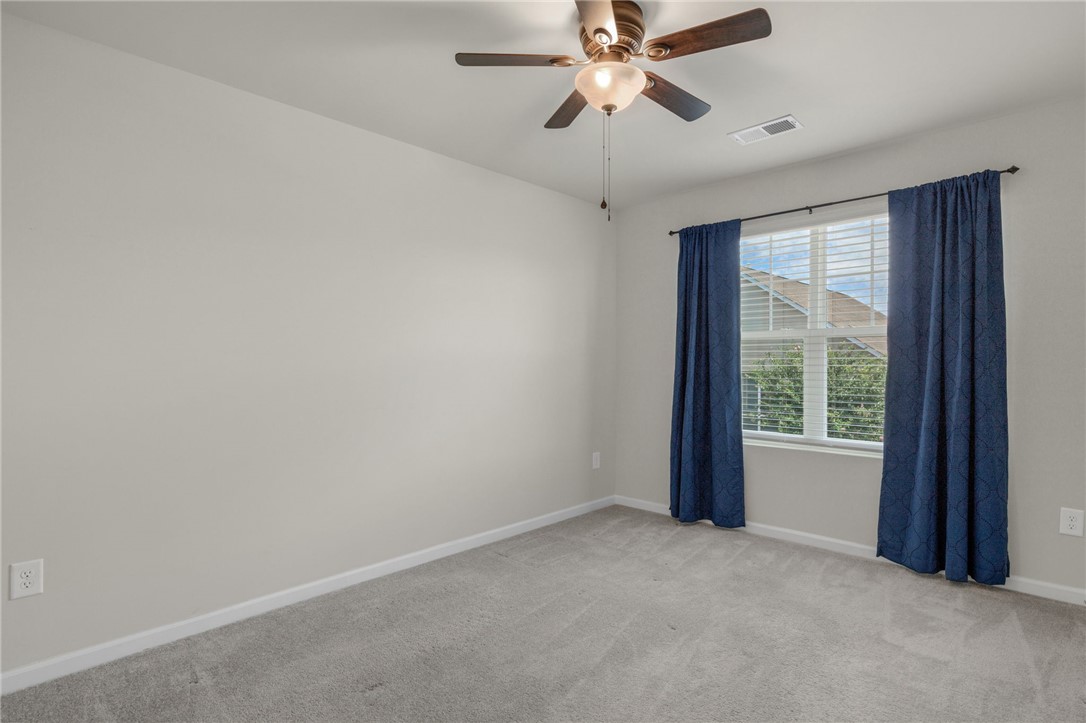 432 Bee Cv Way Pendleton, SC 29670 - Photo 24 of 39 This spacious room offers comfort and versatility, featuring ample natural light and a soft, inviting carpet.