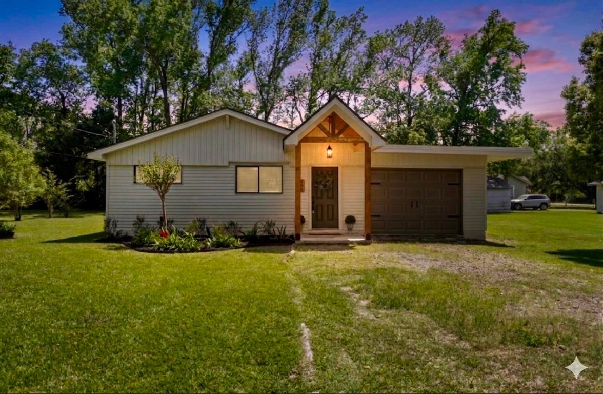 135 James Street Bridge City, TX 77611 - Photo 1 of 12 a front view of a house with a yard and garage