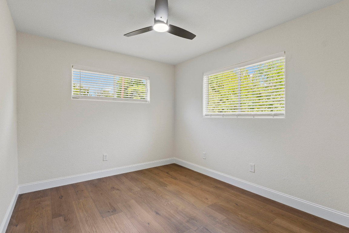 135 James Street Bridge City, TX 77611 - Photo 11 of 12 a view of an empty room with wooden floor and a window