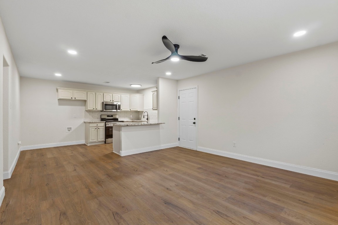 135 James Street Bridge City, TX 77611 - Photo 3 of 12 a view of kitchen with wooden floor and window
