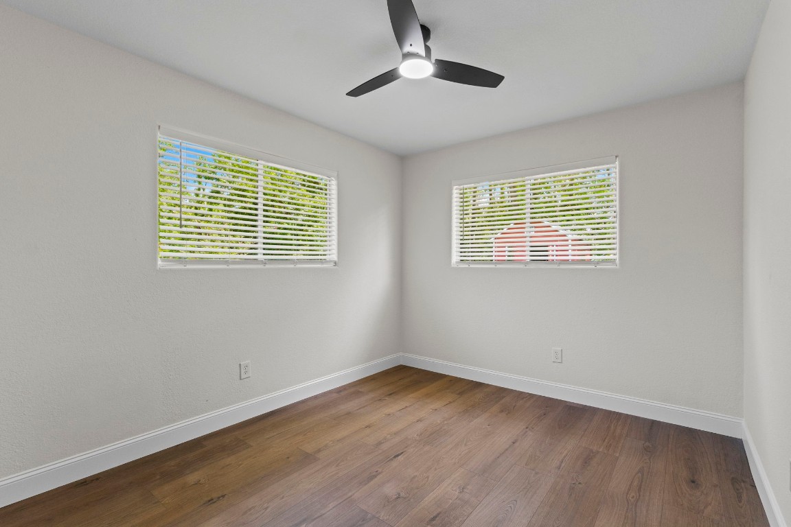 135 James Street Bridge City, TX 77611 - Photo 8 of 12 a view of an empty room with wooden floor and a window
