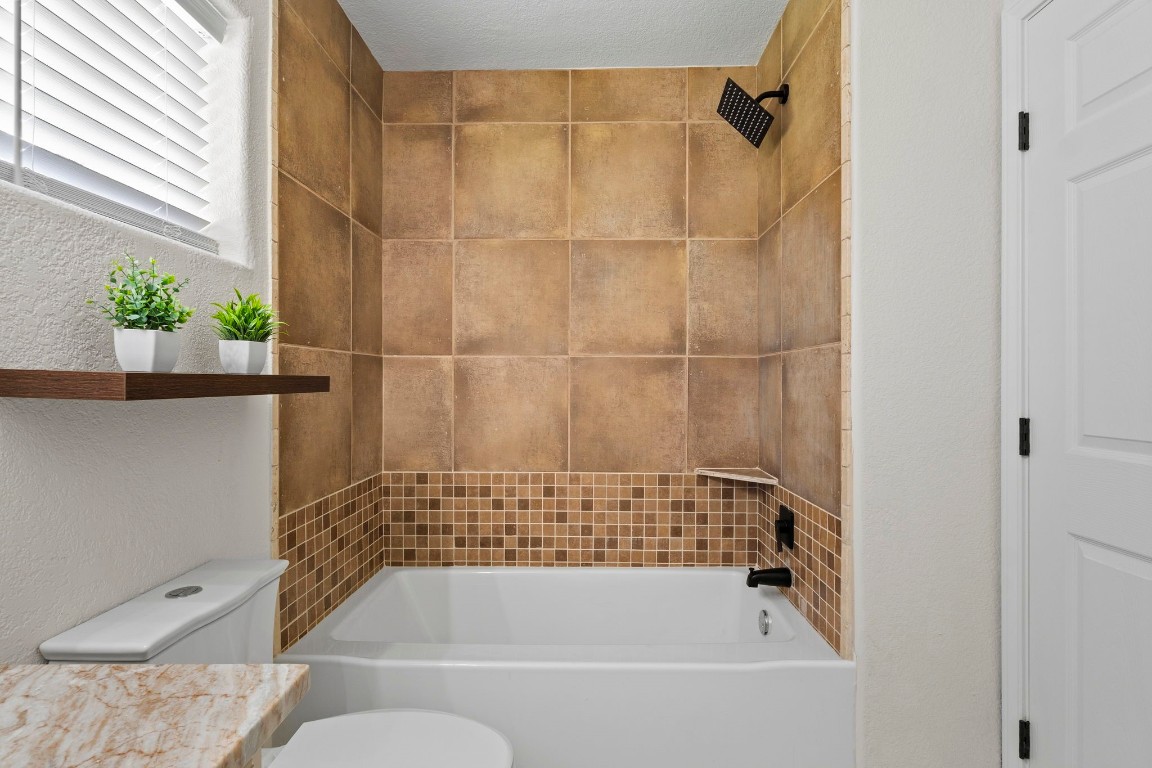 135 James Street Bridge City, TX 77611 - Photo 10 of 12 a bathroom with a bathtub and a shower