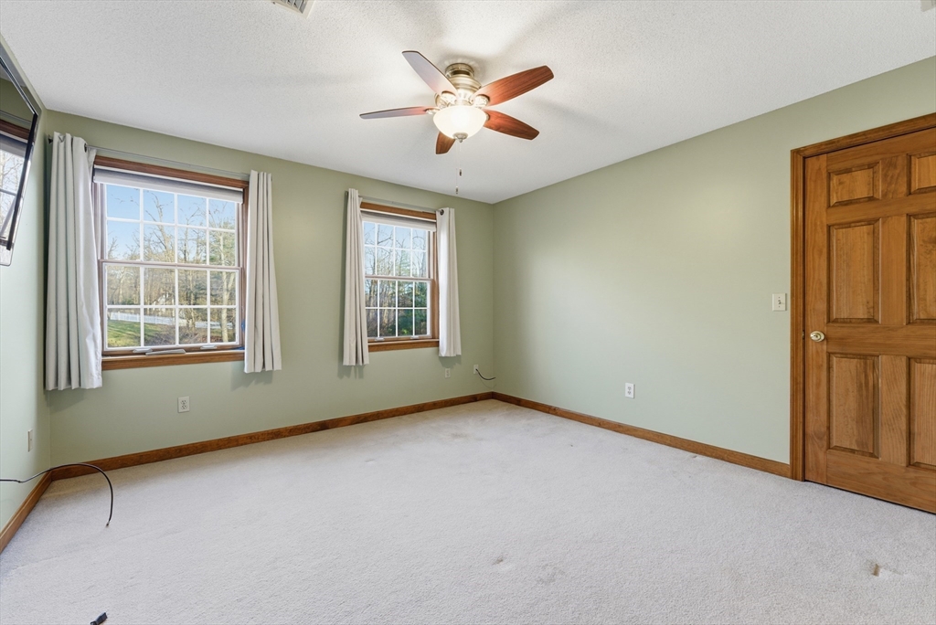 155 South Monson Road Hampden, MA 01036 - Photo 30 of 42 an empty room with windows and ceiling fan