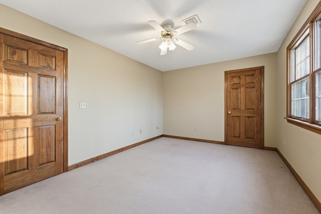 155 South Monson Road Hampden, MA 01036 - Photo 33 of 42 an empty room with windows and chandelier fan