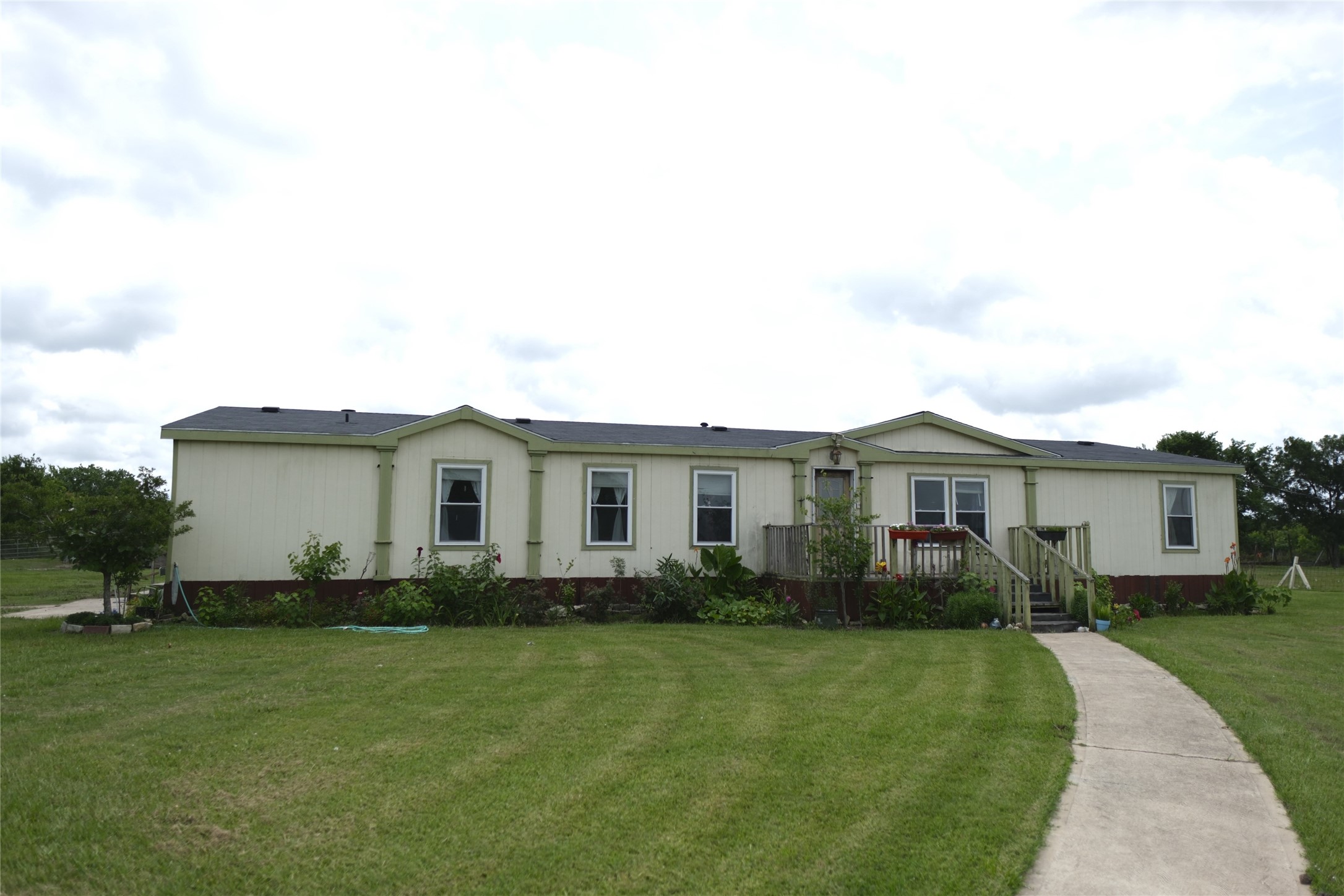 10912 Farm To Market Road 523 Angleton, TX 77515 - Photo 1 of 10 a front view of a house with a garden