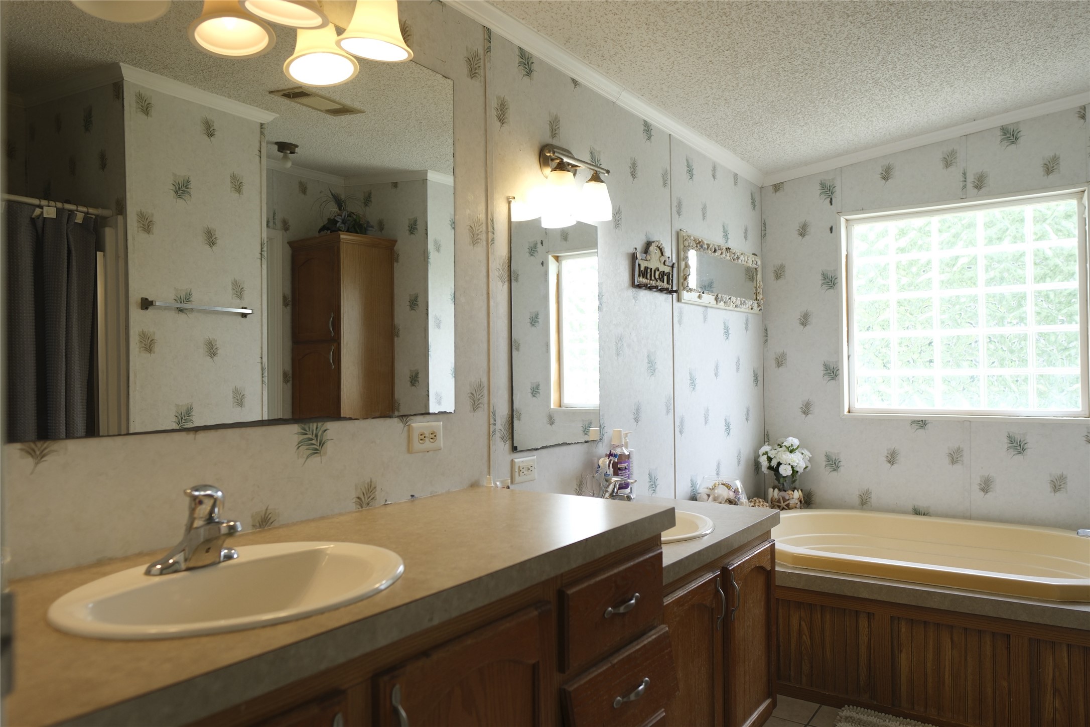 10912 Farm To Market Road 523 Angleton, TX 77515 - Photo 5 of 10 a bathroom with a sink double vanity granite tub shower and a mirror