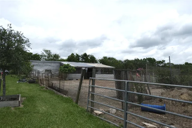 a view of a backyard with a wooden fence