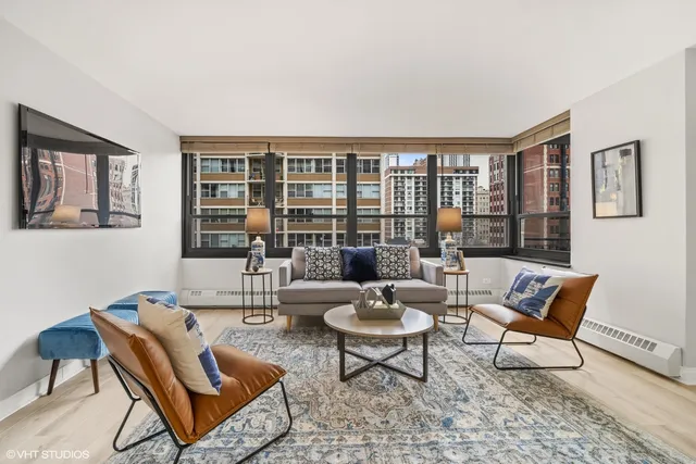 a living room with furniture and a floor to ceiling window
