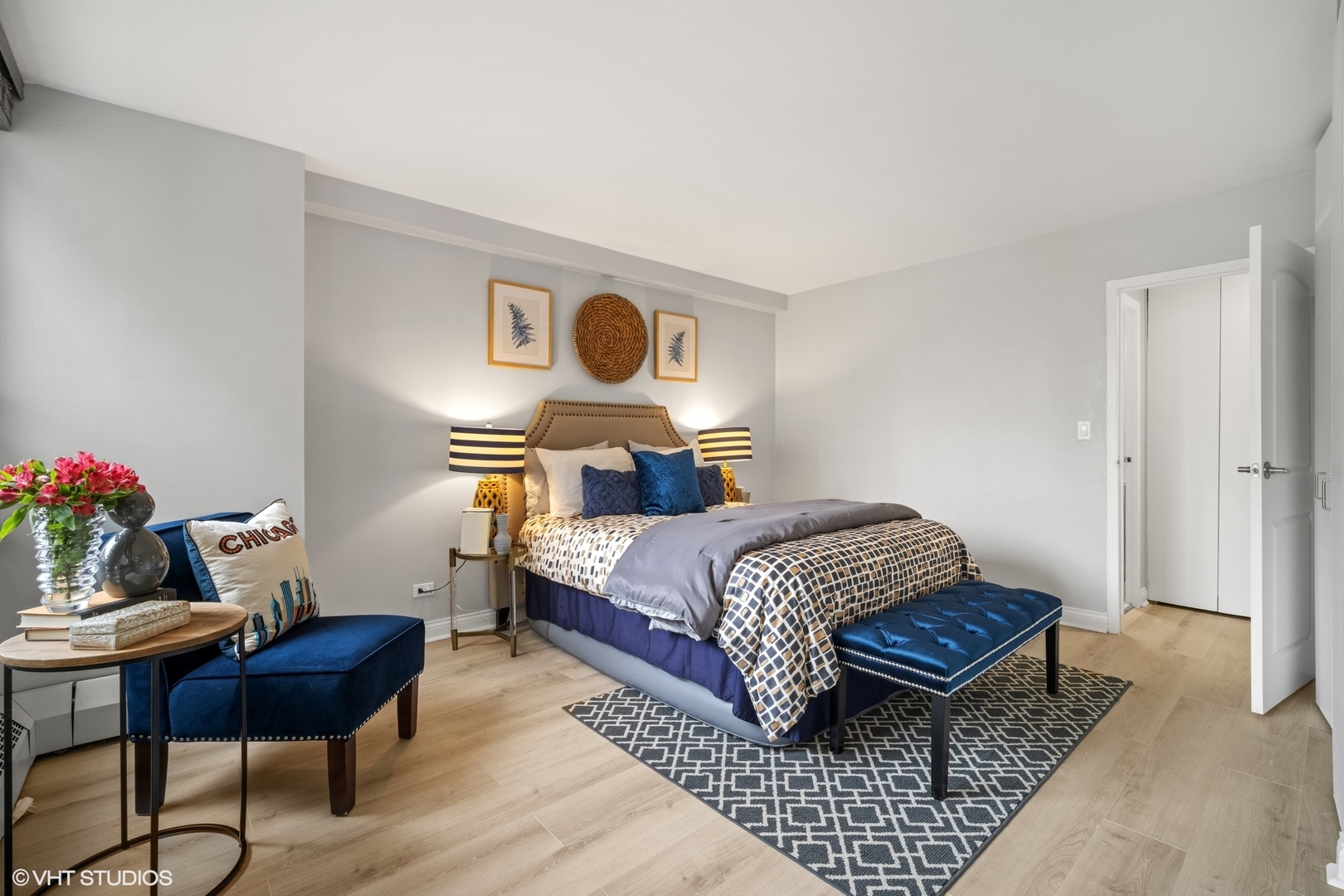 33 East Cedar Street, Unit 8H Chicago, IL 60611 - Photo 9 of 17 a bedroom with a bed and wooden floor