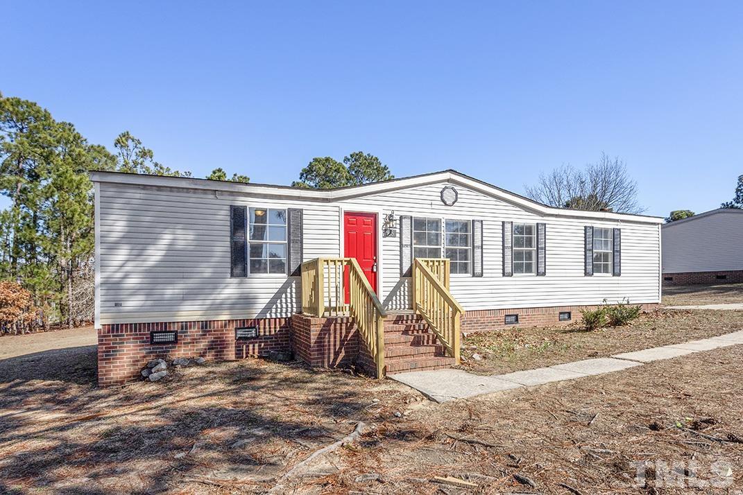 93 Castle Wood Sanford, NC 27332 - Photo 1 of 38 a view of a house with wooden floor and a yard