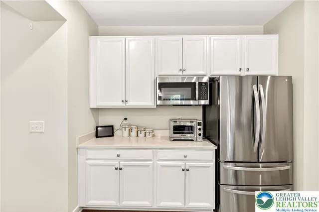 a bathroom with a sink a mirror and a shower