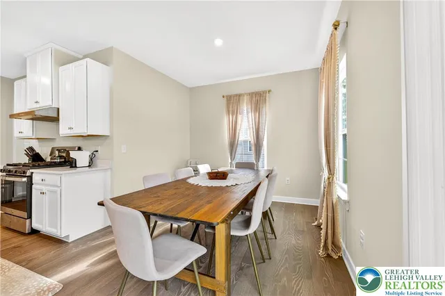 a spacious bedroom with a bed and a wooden floor