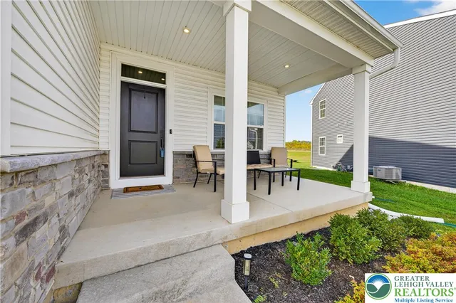 a view of swimming pool with outdoor seating and plants