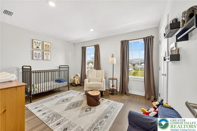 a bedroom with a bed and a lamp