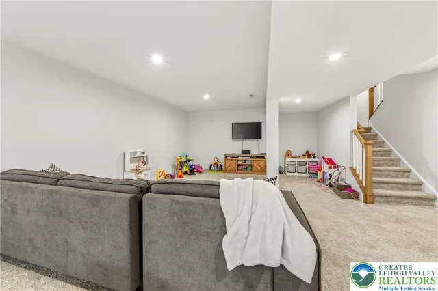 a view of a backyard with table and chairs potted plants and large tree