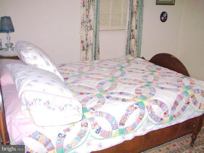 1499 Kimblewick Road Potomac, MD 20854 - Photo 7 of 17 a bedroom with a bed and a window