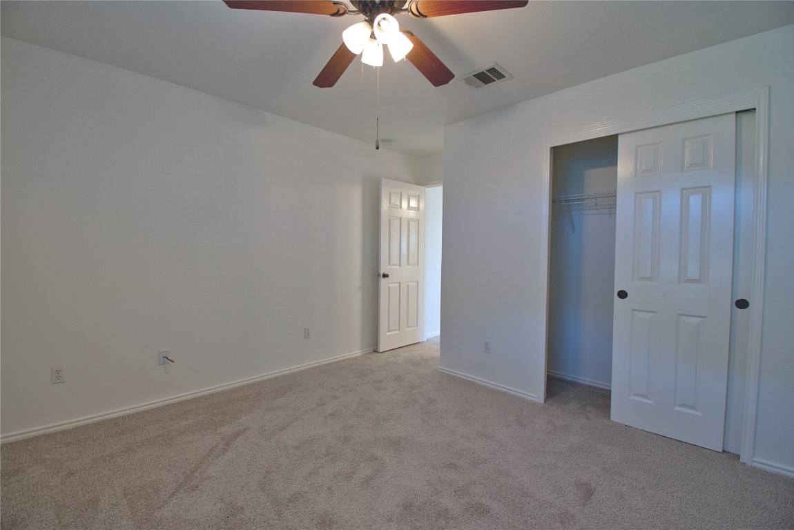 3112 Blue Ridge Drive Round Rock, TX 78681 - Photo 19 of 22 a view of an empty room and chandelier fan