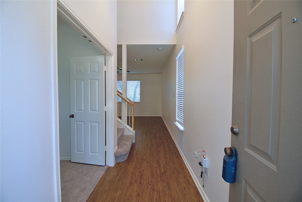 3112 Blue Ridge Drive Round Rock, TX 78681 - Photo 4 of 22 a view of a hallway with wooden floor and staircase