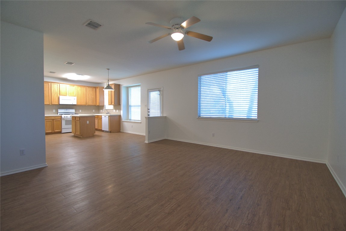 3112 Blue Ridge Drive Round Rock, TX 78681 - Photo 6 of 22 a view of an empty room with a window and wooden floor