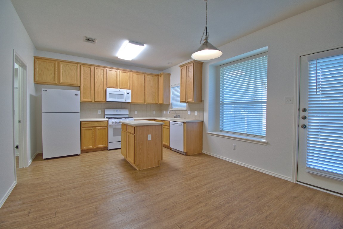 3112 Blue Ridge Drive Round Rock, TX 78681 - Photo 7 of 22 a kitchen with stainless steel appliances granite countertop a stove a sink dishwasher and a refrigerator