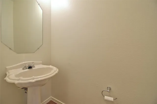 a bathroom with a sink and mirror