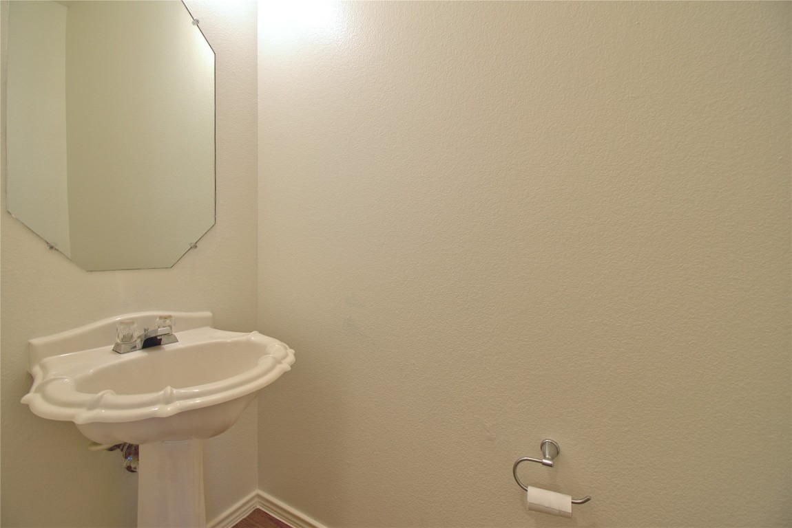 3112 Blue Ridge Drive Round Rock, TX 78681 - Photo 9 of 22 a bathroom with a sink and mirror